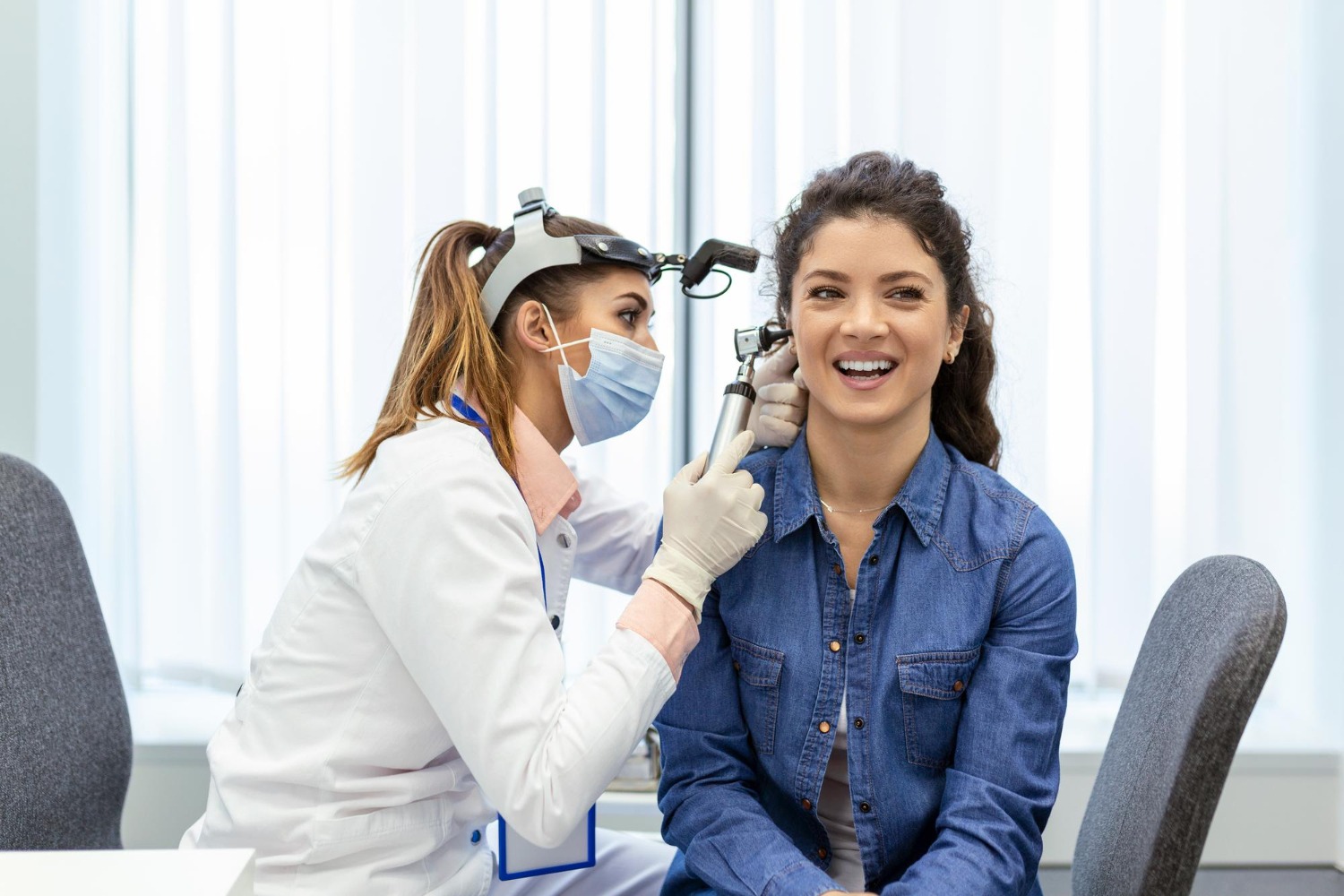 Audiologist checking a patient’s ear before ear wax removal